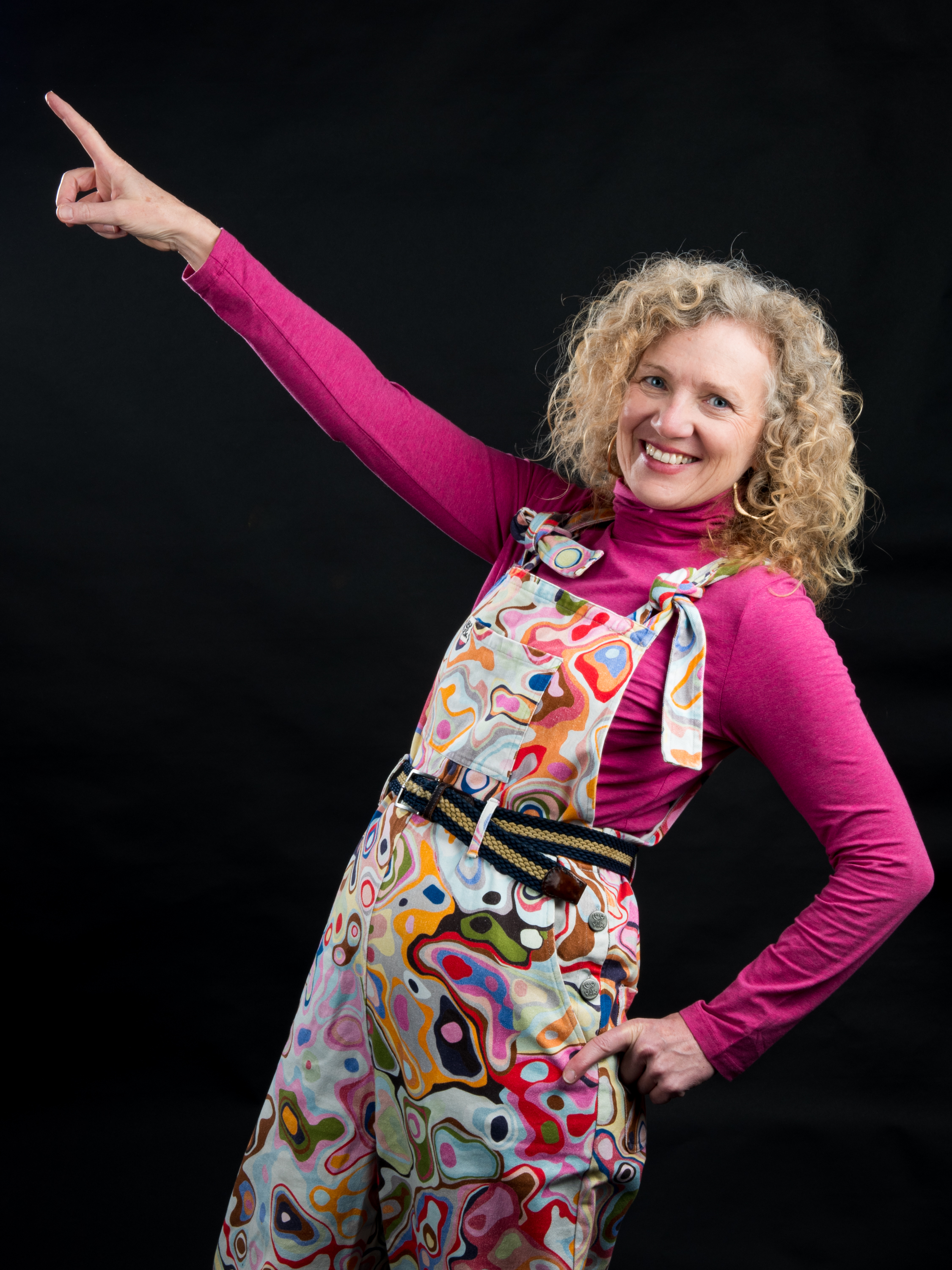 Mikyla Limpkin smiling and pointing upwards